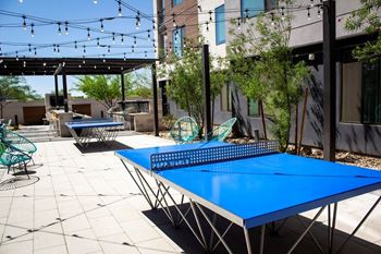 Outdoor gaming area with pool table and ping-pong